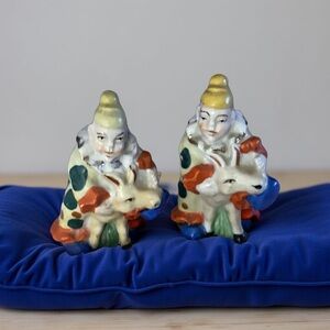 Colorful Ceramic Figurines on Blue Cushion